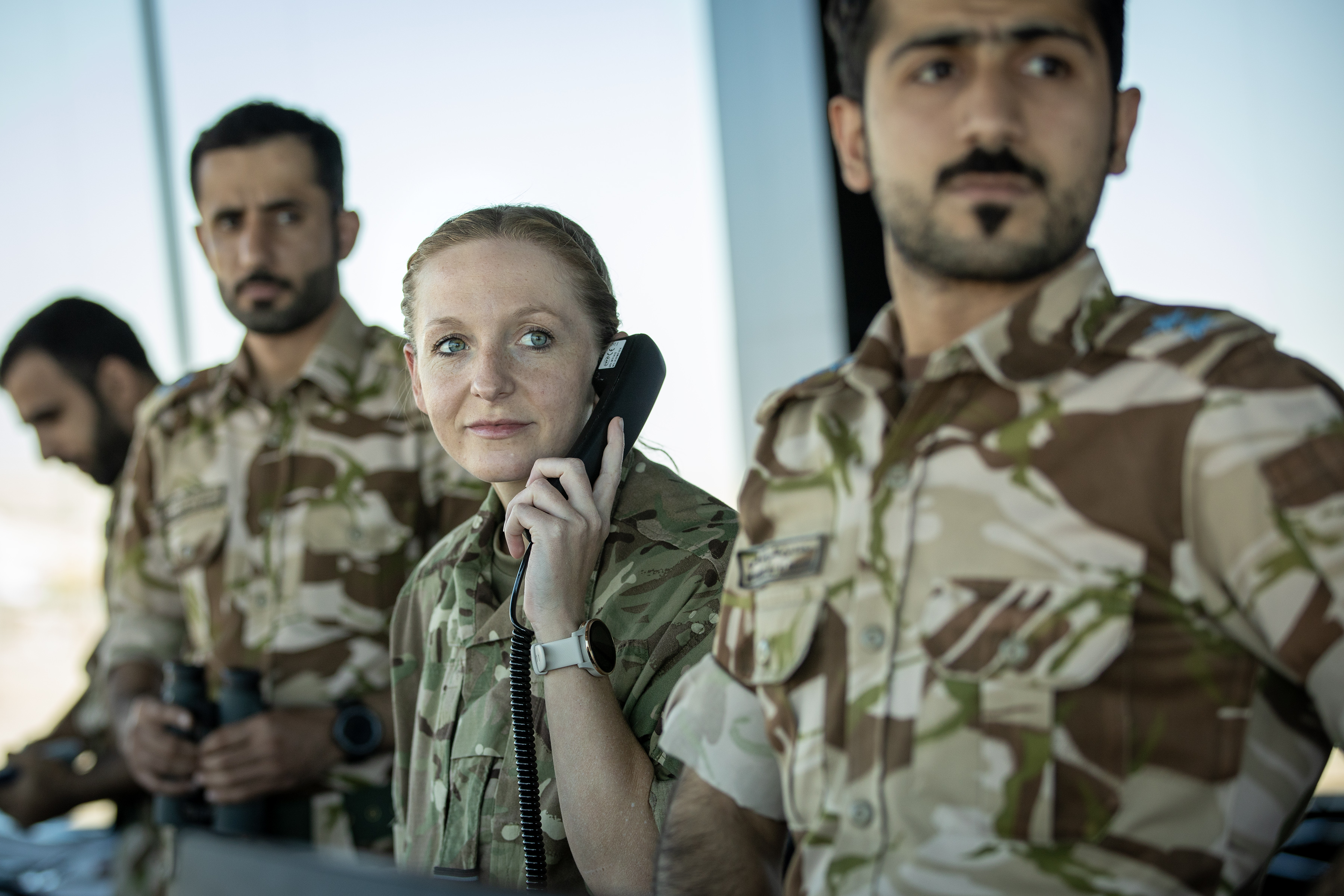 Image shows personnel with telephones.